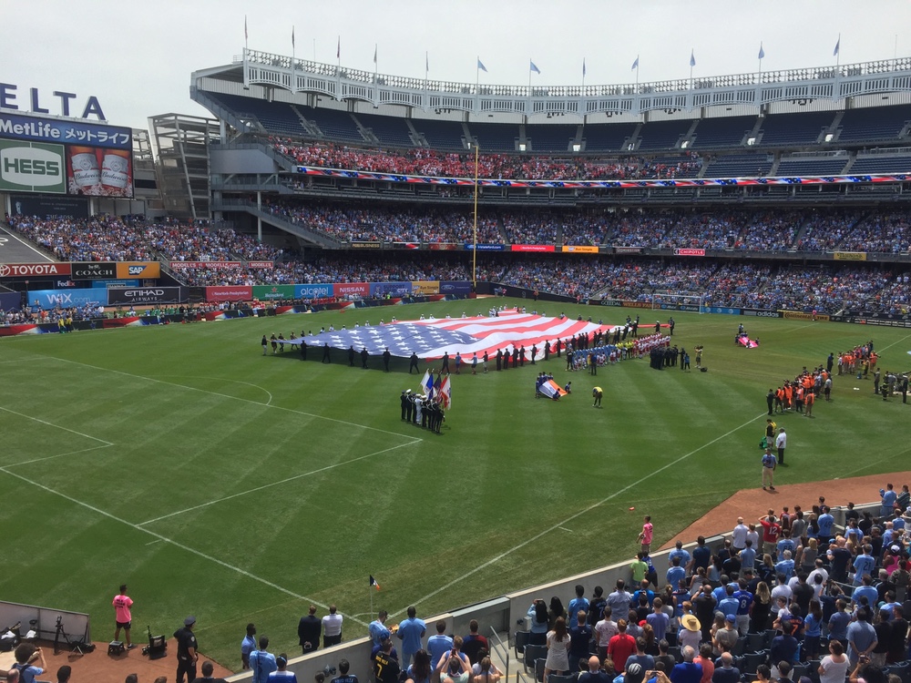 Military Appreciation Day, featuring an America-shaped flag banner – photo VioletCrown.soccer
